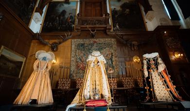 Three costumes on display in Elizabethan Great hall