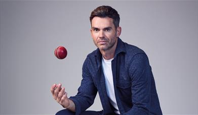 Jimmy Anderson throwing a cricket ball in the air
