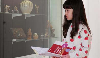 A young girl browsing one of the exhibits at the Museum of East Asian Art