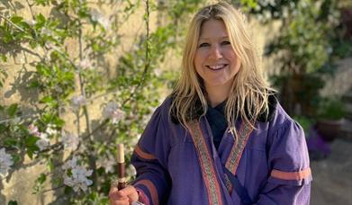 Woman in purple robes smiling