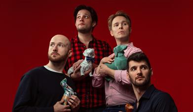 Shoot from the hip members pose with dog ornaments