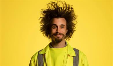 Viggo Venn in a high vis vest on a yellow background