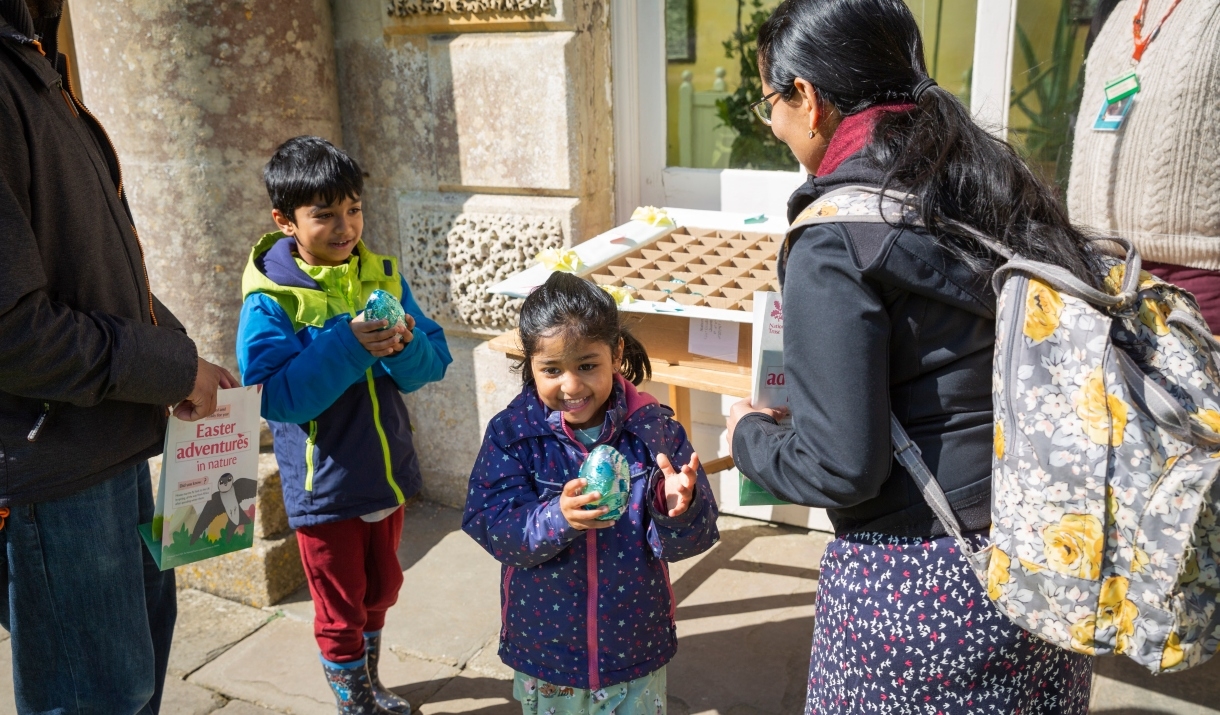 A family enjoying an Easter egg trail at Dyrham Park