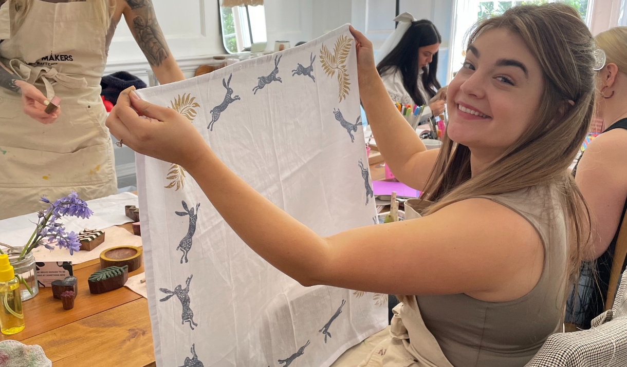 women holding tea towel