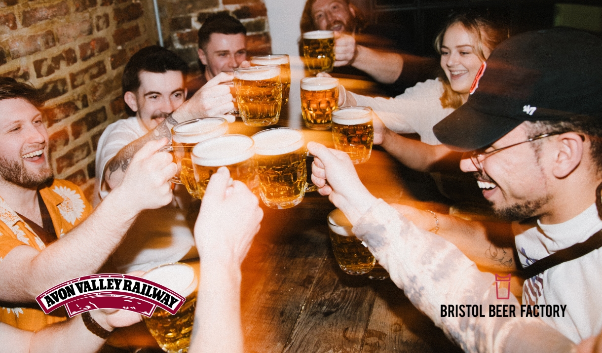 Some people drinking beer at a table.