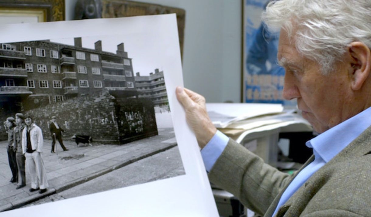 man looking at large black and white photograph