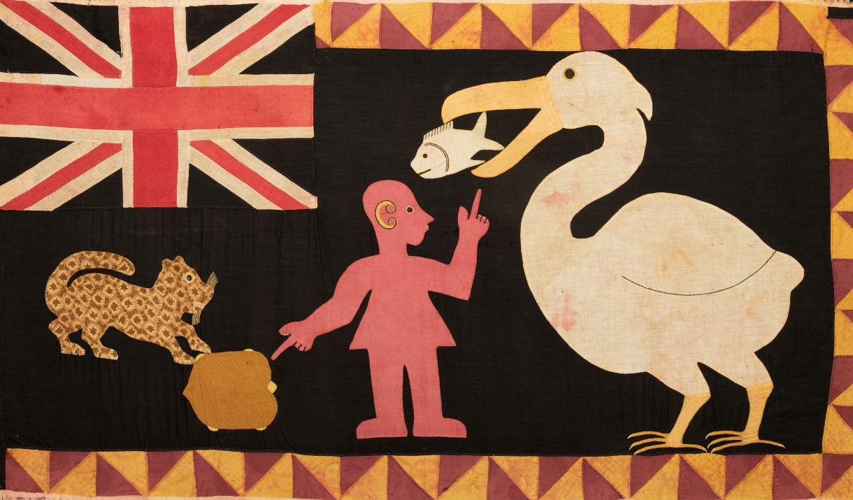 Brightly coloured flag including a pelican and a fish