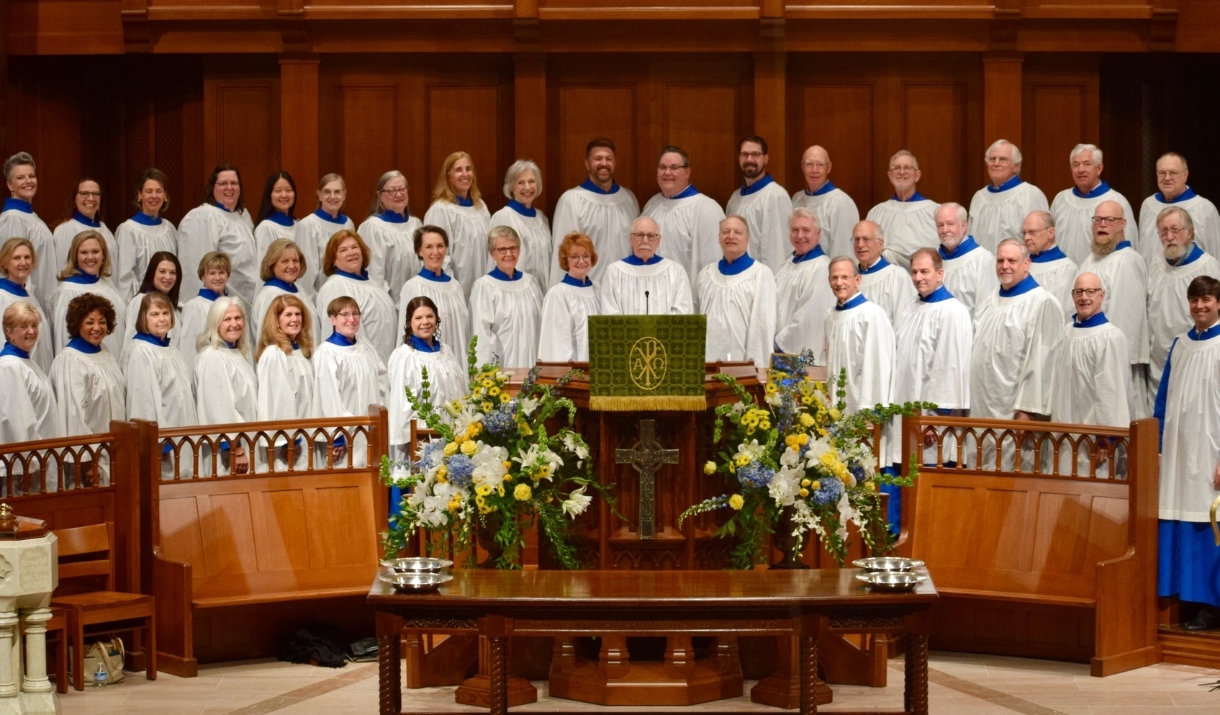 A church choir standing on a dais.