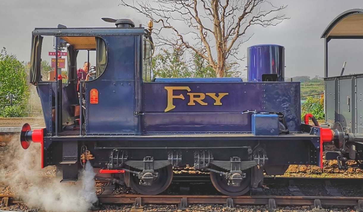 Blue locomotive with gold writing on it