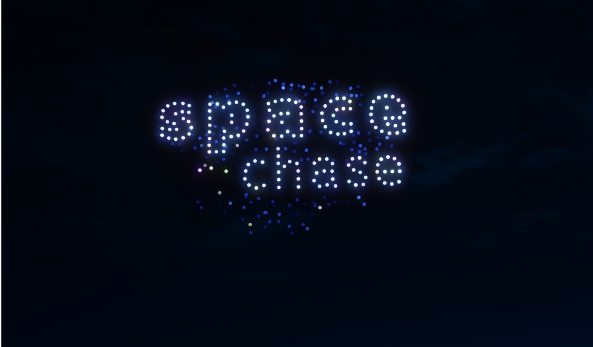 The image shows an outdoor area with hundreds of drones making the words Space Chase.
