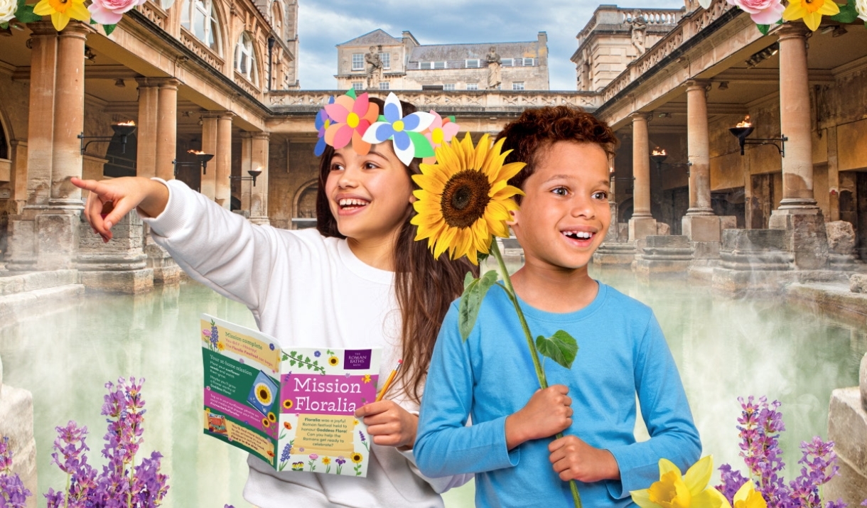 two children holding flowers in front of the Great Bath
