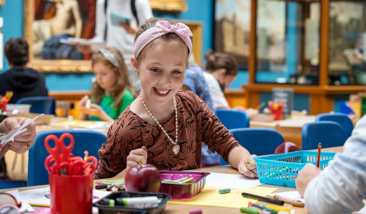 Girl working on a craft project at a table in the Victoria Art Gallery