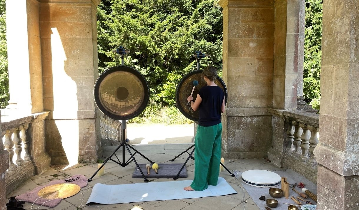 a woman banging a gong