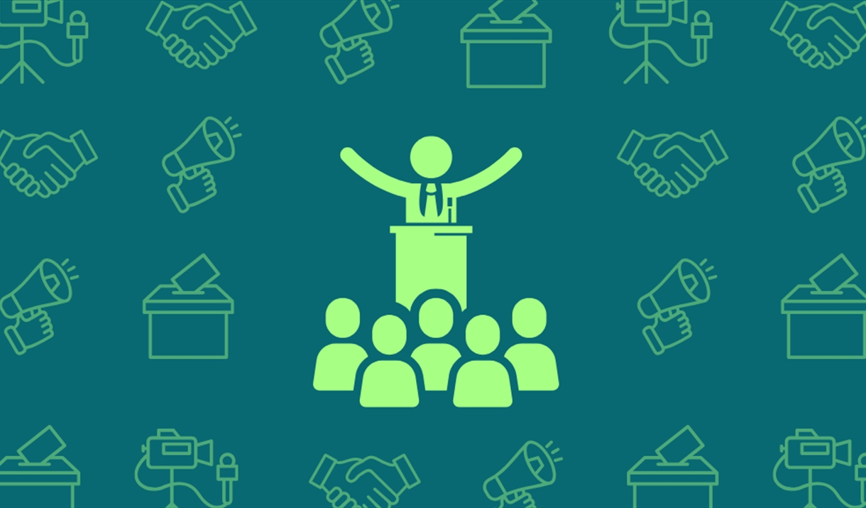 Icon of person giving a speech at a lectern in front of a crowd. There are other icons representing media and politics in the background.