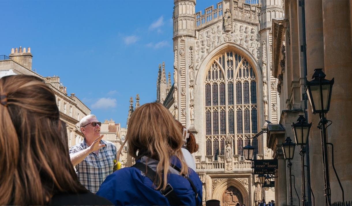 Tour guide discussing the Roman Baths while in front of the Cathedral
