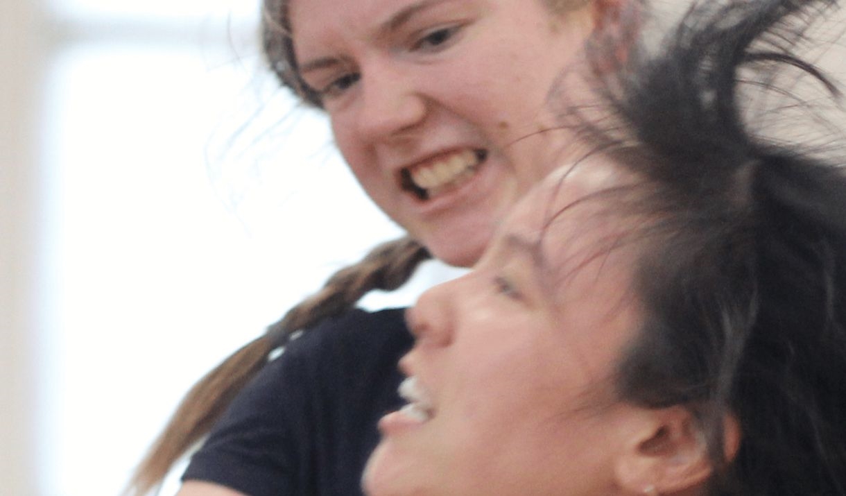 Action shot of two individuals stage combatting. Sparkfest logo in top corner