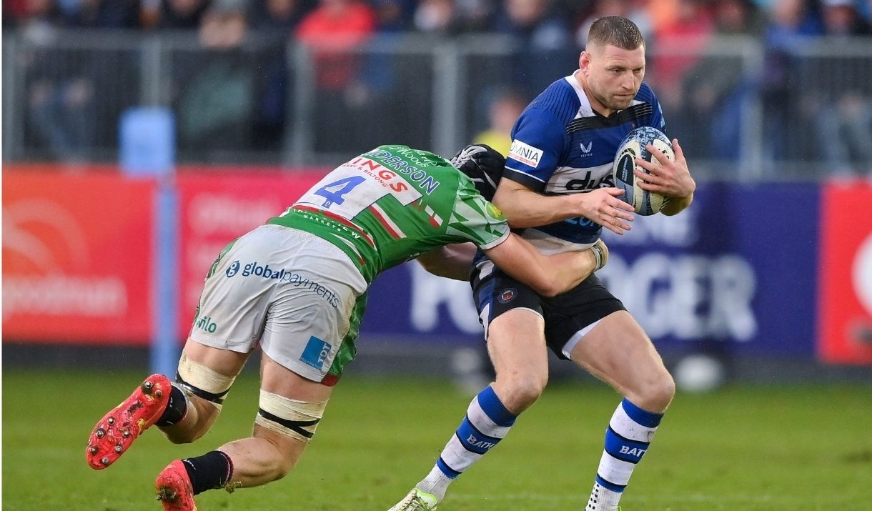 a man playing rugby being tackled