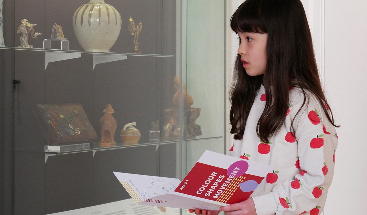A young girl browsing one of the exhibits at the Museum of East Asian Art