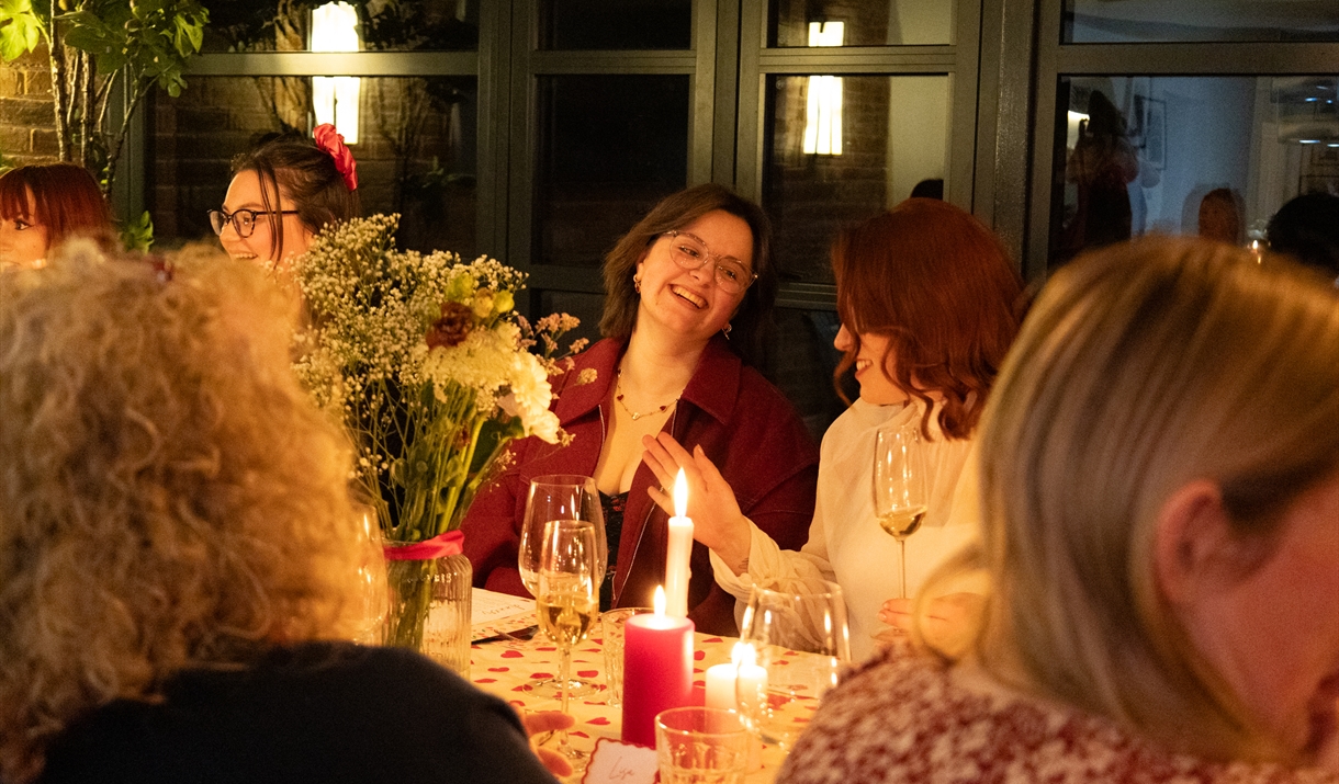 Women smiling at dining table
