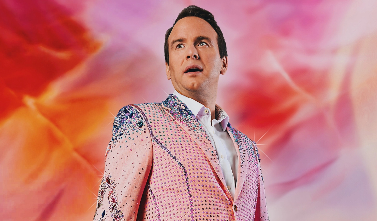 Matt Forde in a glitter suit looking up in awe