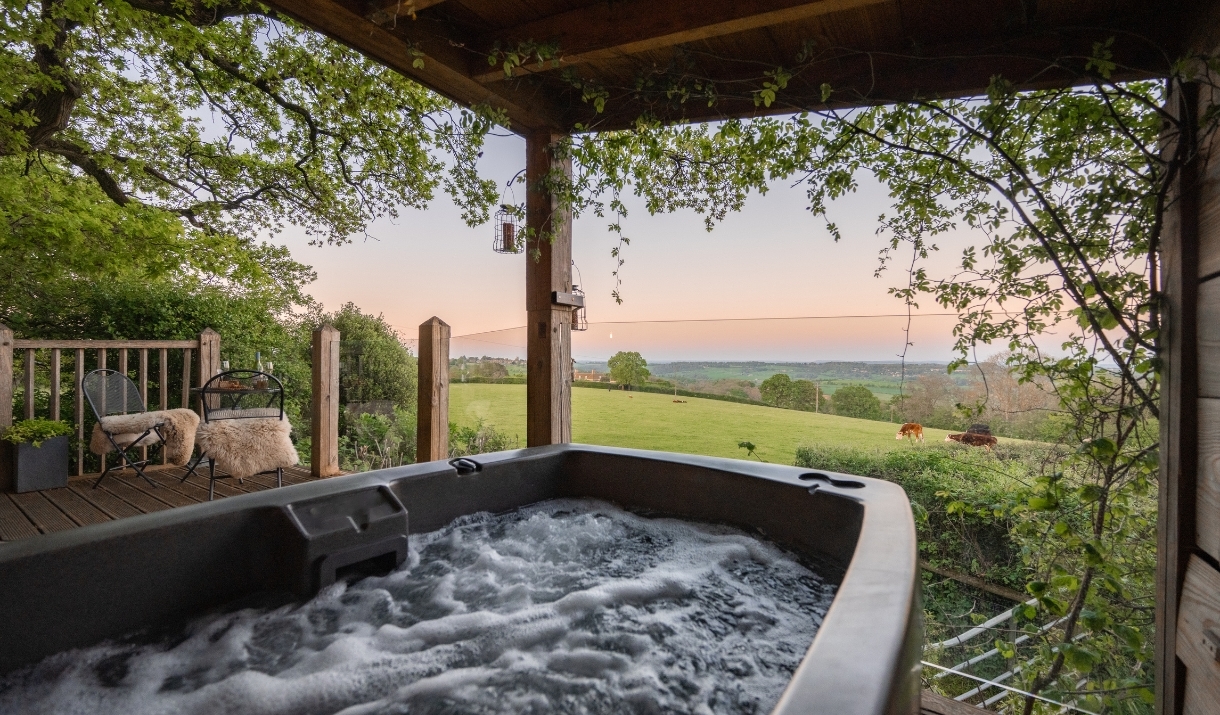 View of the fields from the hot tub on the porch of the treehouse