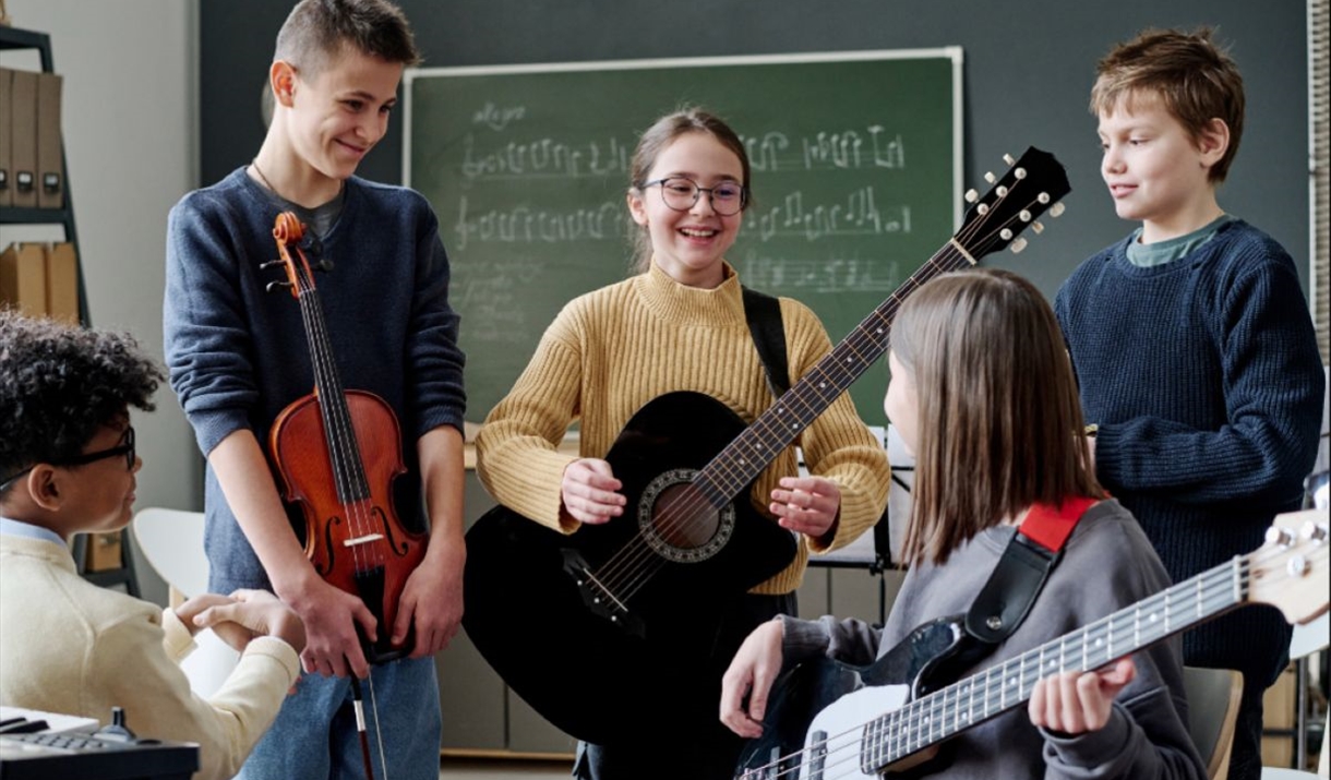 children holding guitars
