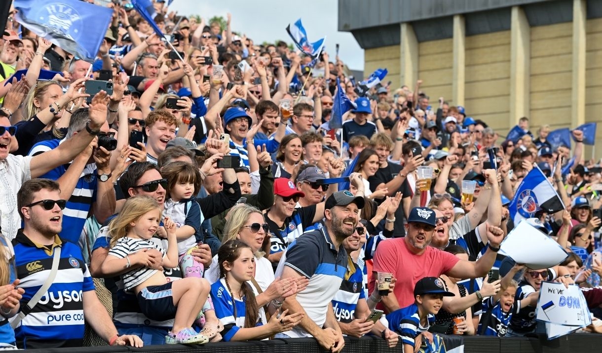 a crowd of people cherring wearing bath rugby shirts
