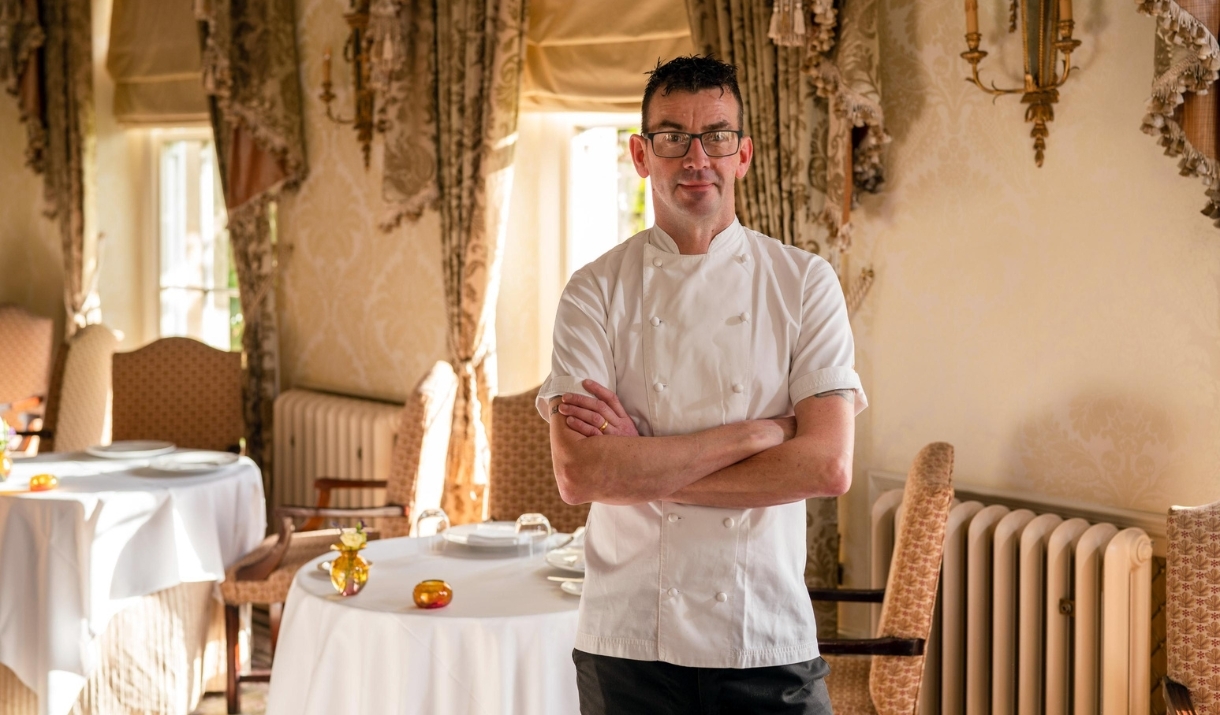 A man wearing a chef's uniform with his arms folded at the Restaurant Hywel Jones in Lucknam Park, near Bath