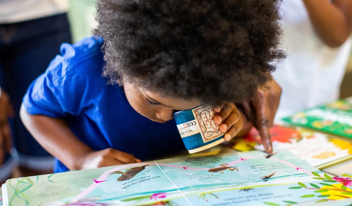 child looks closely at picture map