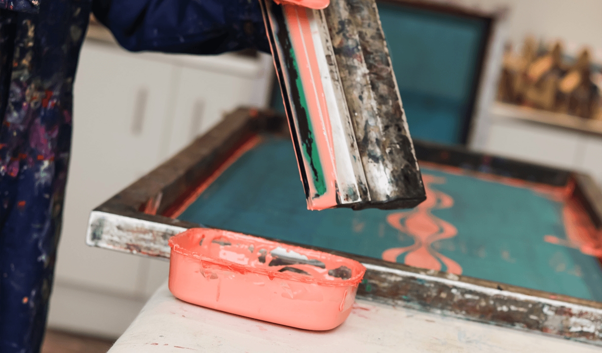 Someone scraping paint off a squeegee