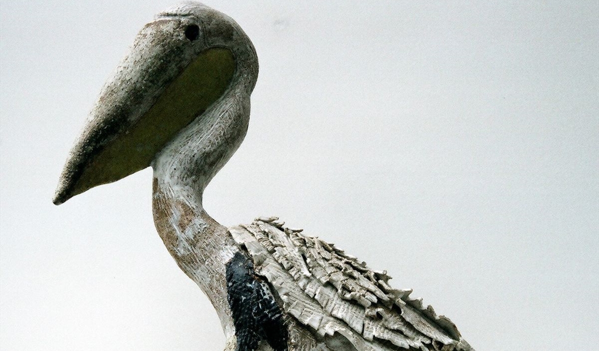 A sculpture of a pelican in clay