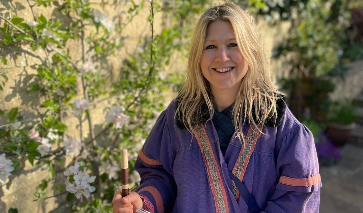 Woman in purple robes smiling
