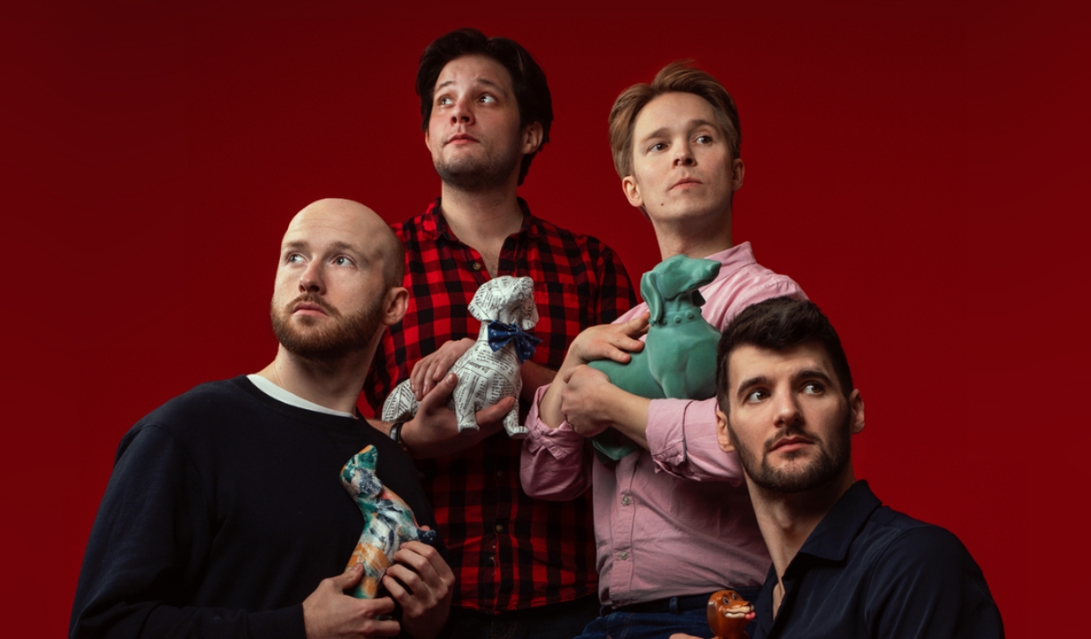Shoot from the hip members pose with dog ornaments