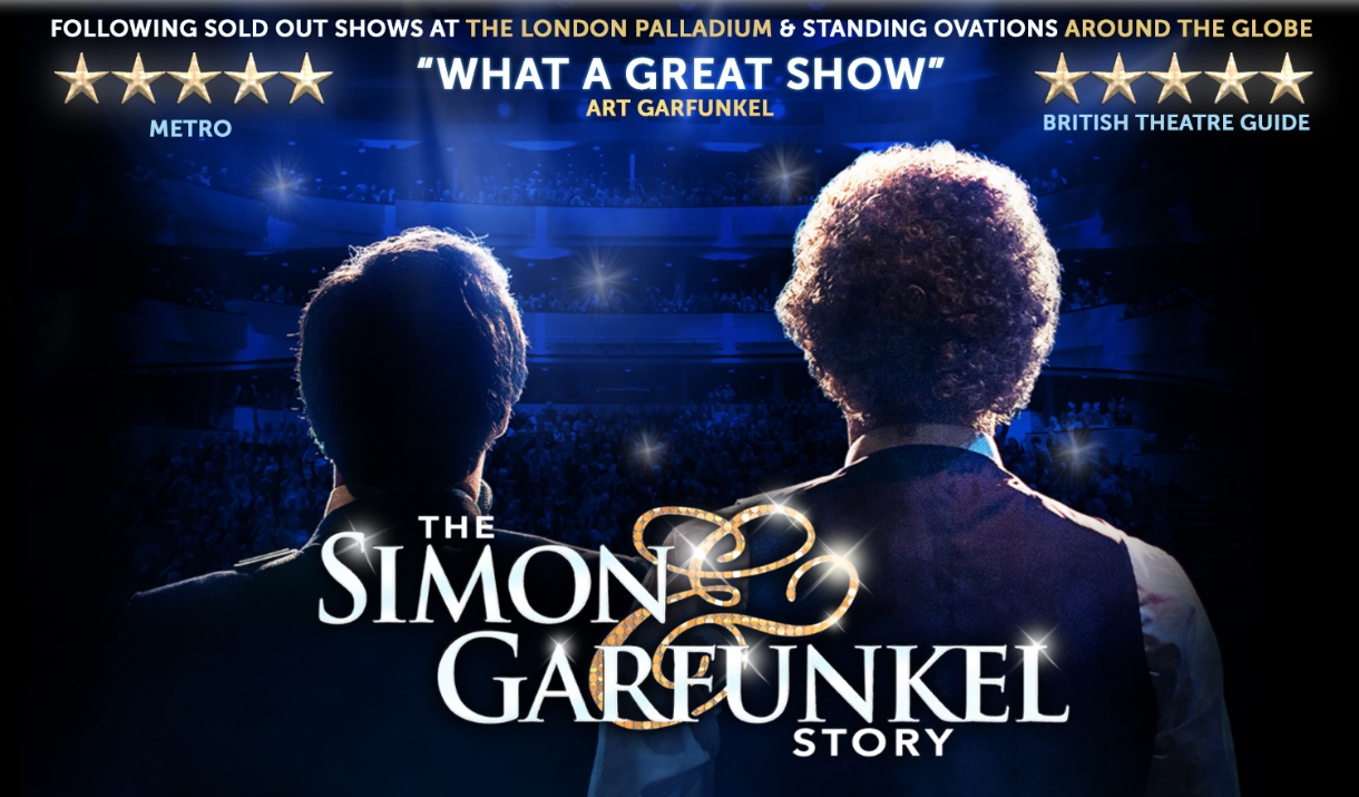 Two men face a theatre of people, their backs towards the camera.