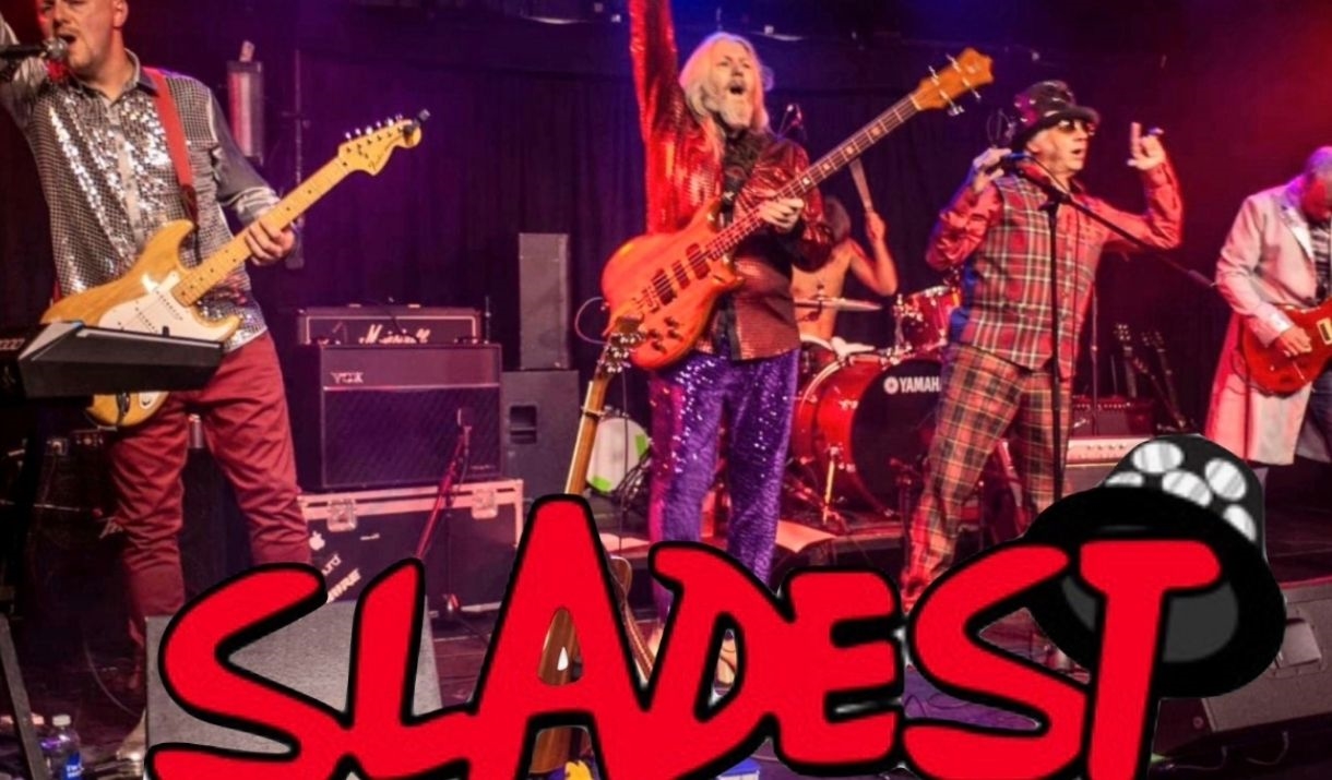 A photo of the band Sladest siing live on stage
