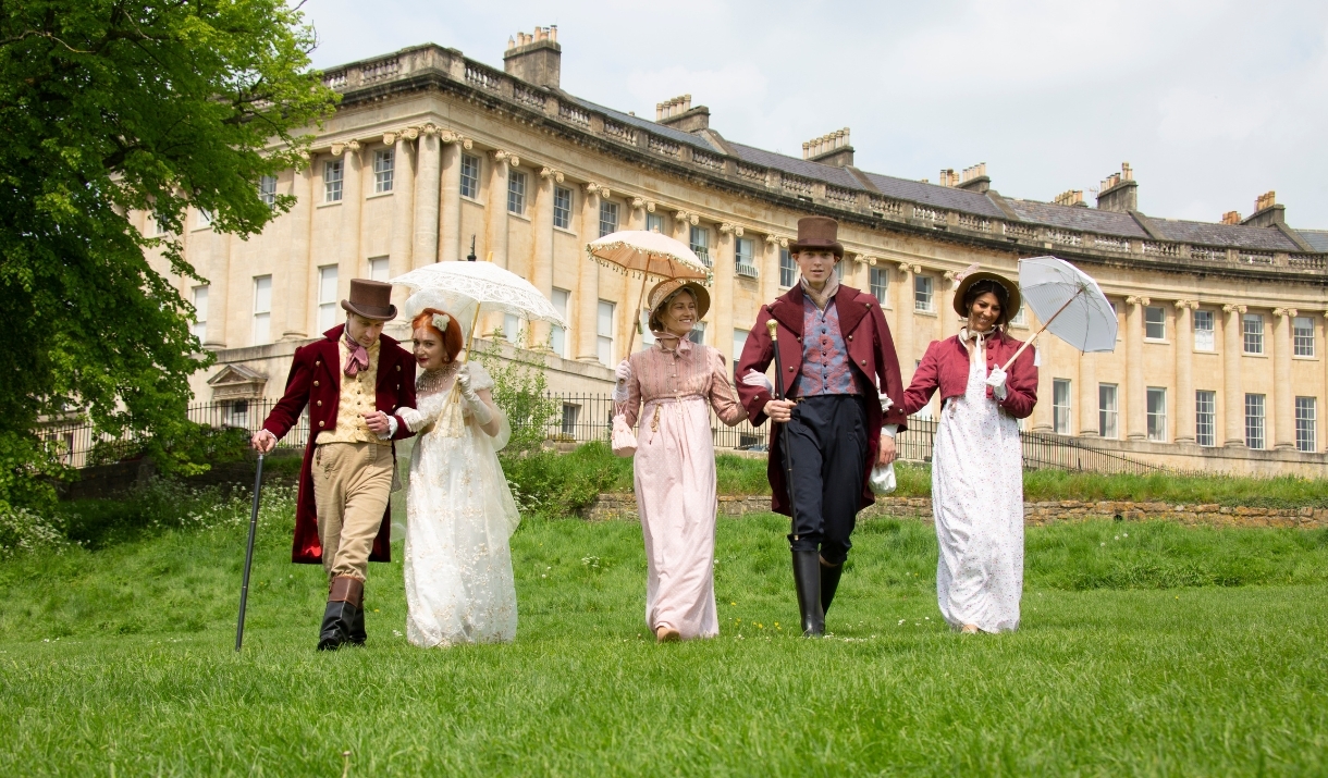 A grpoup of people wearing Regency costume at the Royal Crescent in Bath