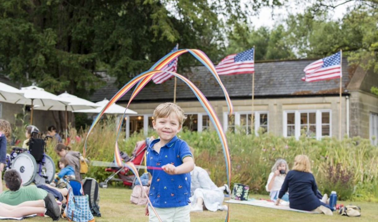 child with rainbow ribbon