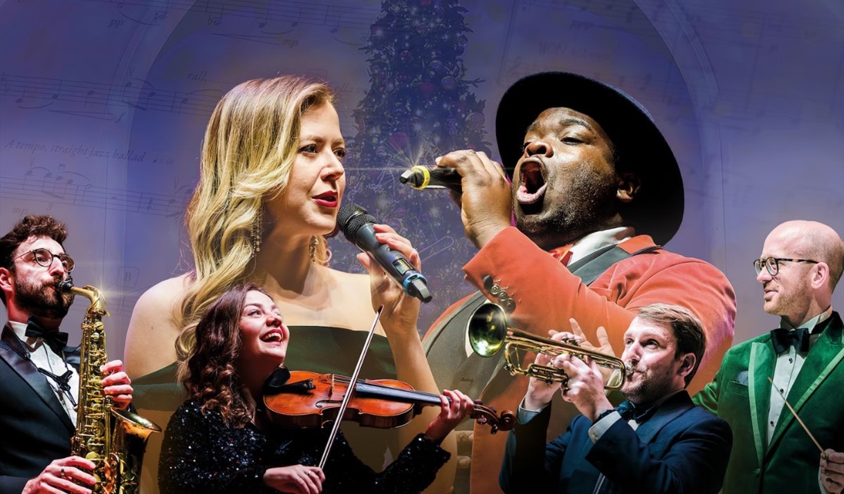 Vocalists and instrumentalists in front of a Christmas tree