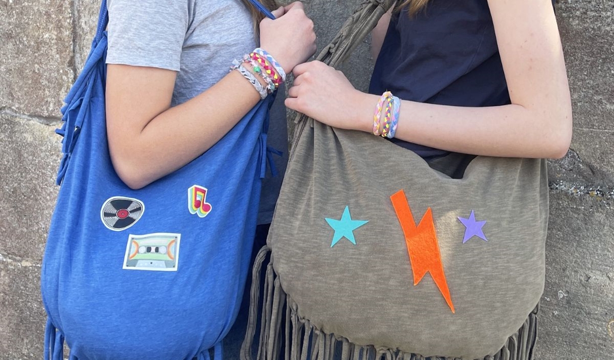 image of 2 teenagers holding upcycled bags
