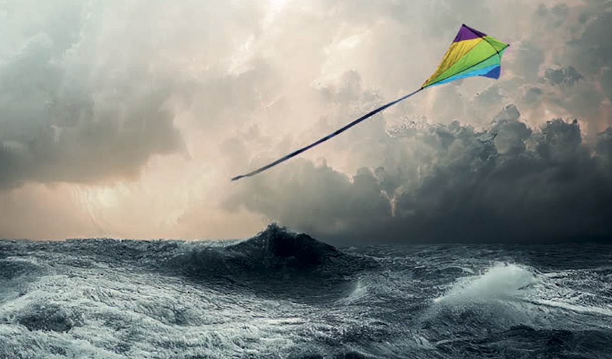 Waves in the sea and kite flying above