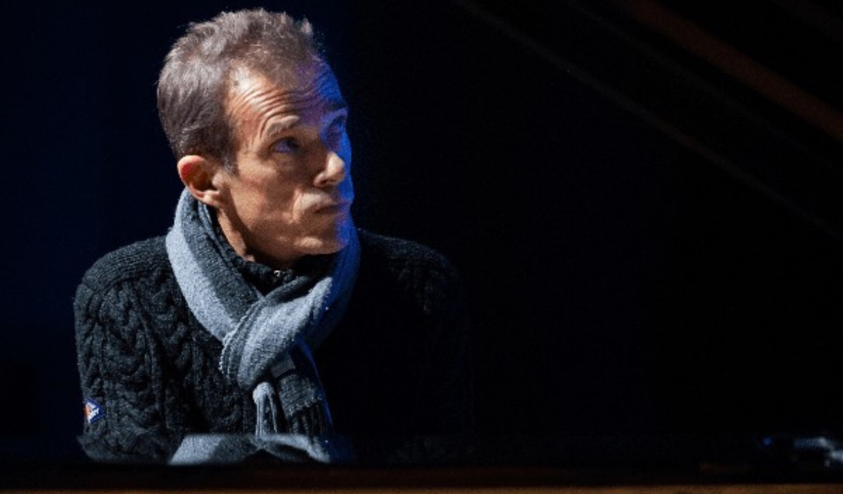 a man in a scarf in a dark room