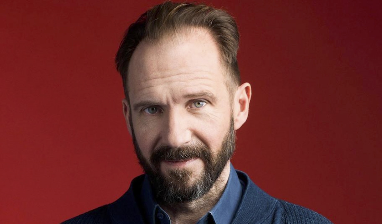 Head shot of man in front of red background