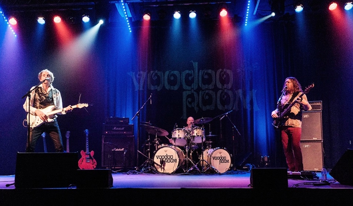 A photo of a rock band playing live on a stage