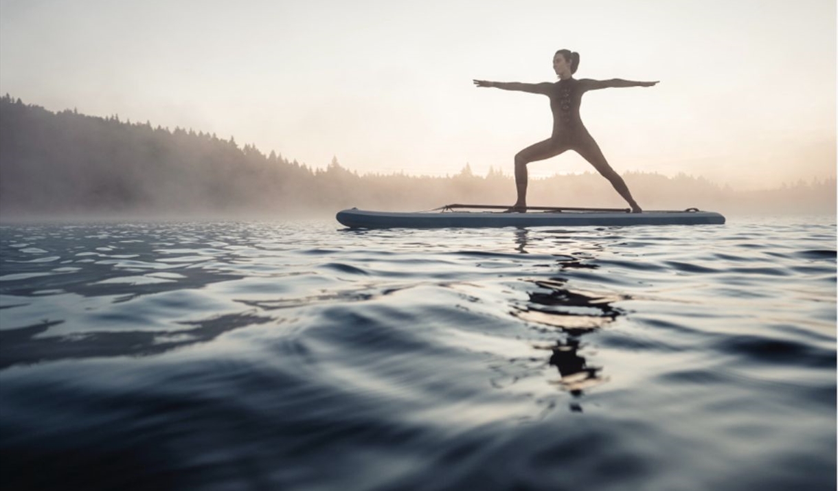 Woman balancing on a surfboard in the sea