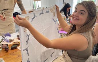 women holding tea towel