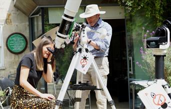 People looking through telescopes in the Herschel garden
