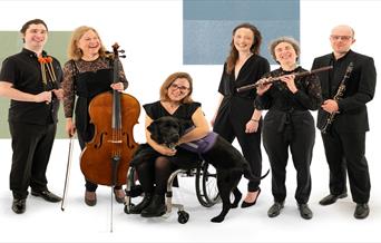A group of orchestra members holding instruments