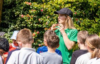 children gathered listening to guided walk leader