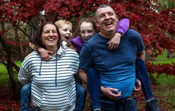 family of four in autumn woodland
