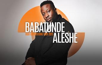 Babatunde Aleshe sat looking at the camera with orange semi circle shapes behind him